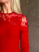 Mature woman wearing designer Ulla Johnson's Clemence LS Lace Dress in Cerise red virgin wool knit with delicate lace at the bodice and hemline striking sophisticated occasion elegance