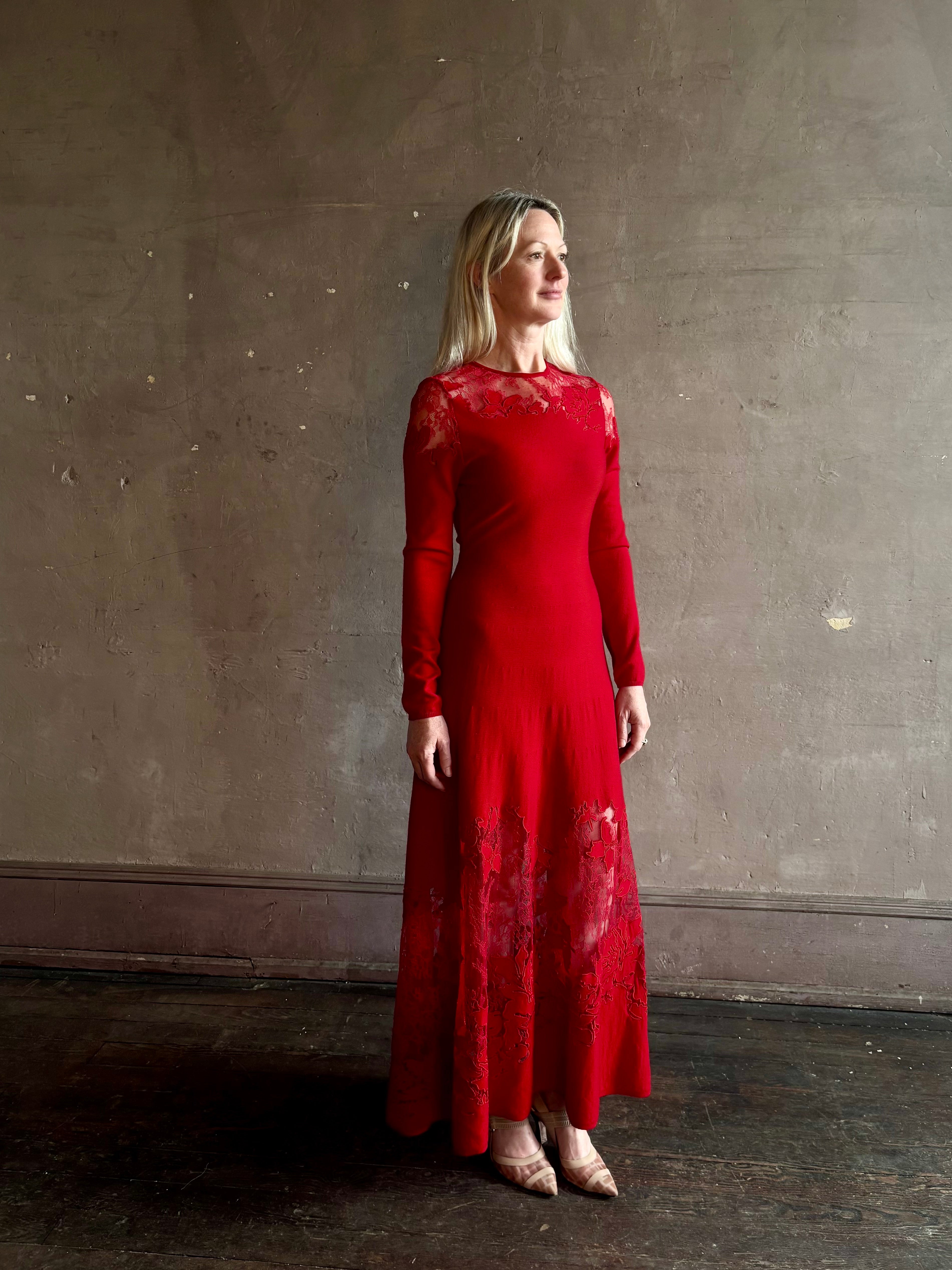 Mature woman wearing designer Ulla Johnson's Clemence LS Lace Dress in Cerise red virgin wool knit with delicate lace at the bodice and hemline striking sophisticated occasion elegance