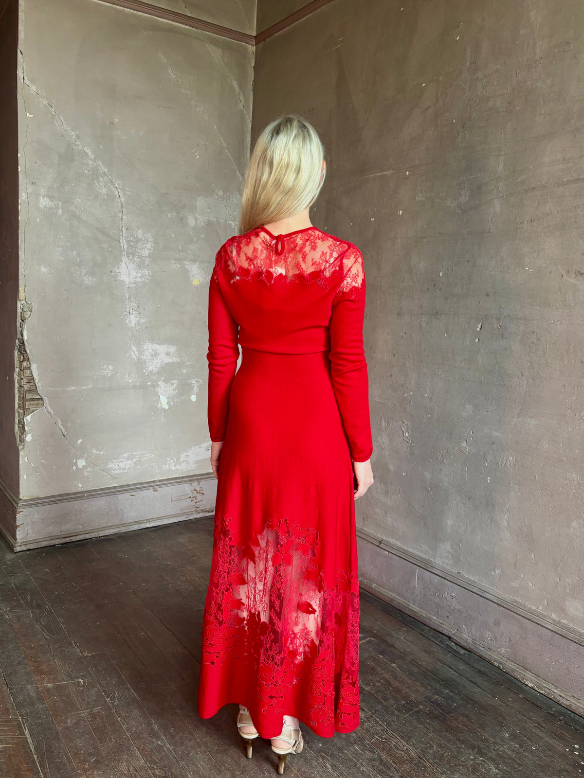 Mature woman wearing designer Ulla Johnson's Clemence LS Lace Dress in Cerise red virgin wool knit with delicate lace at the bodice and hemline striking sophisticated occasion elegance