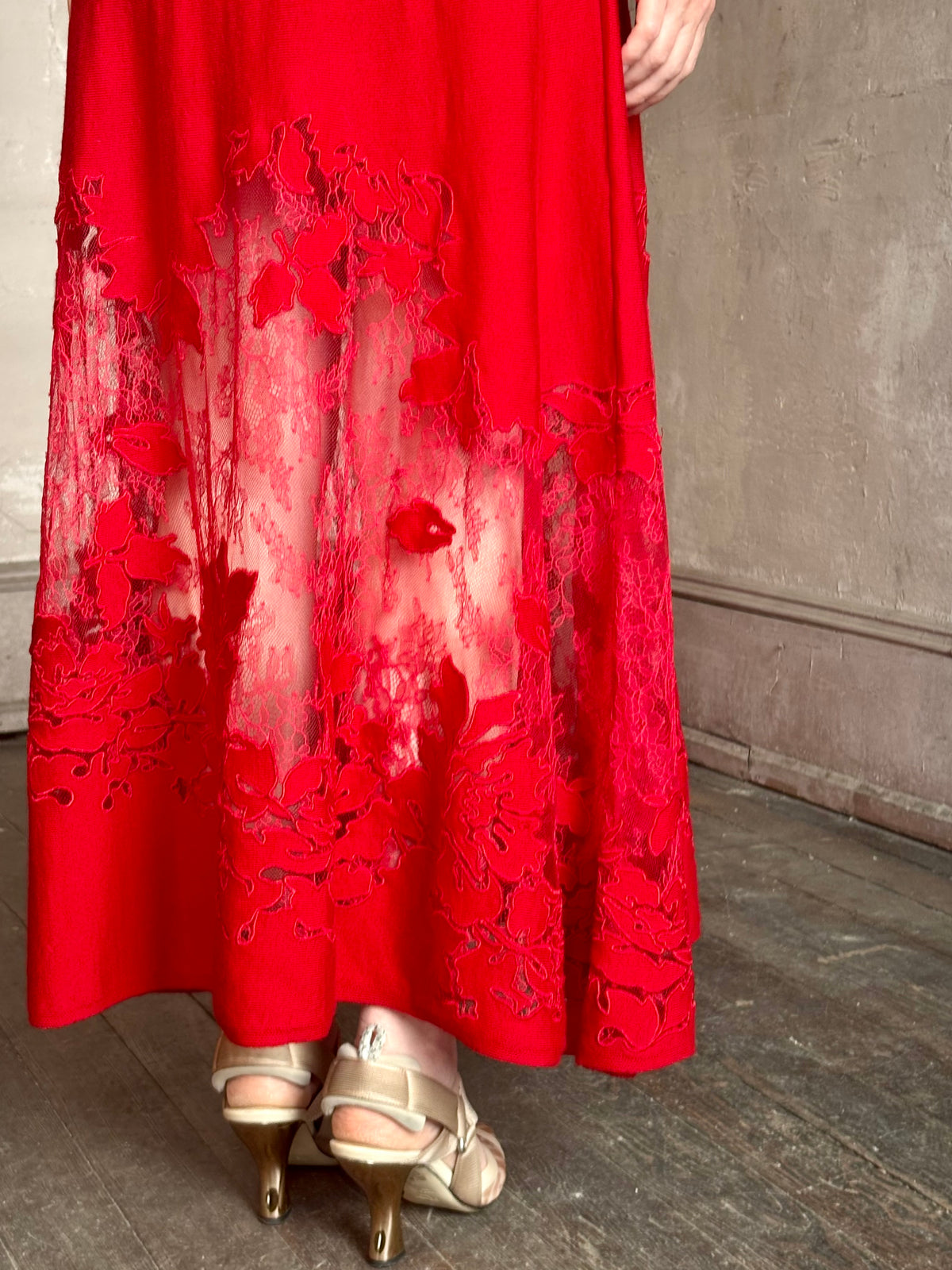 Mature woman wearing designer Ulla Johnson's Clemence LS Lace Dress in Cerise red virgin wool knit with delicate lace hemline