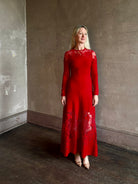 Mature woman wearing designer Ulla Johnson's Clemence LS Lace maxi Dress in Cerise red virgin wool knit A-line delicate lace at the bodice and hemline striking sophisticated occasion elegance