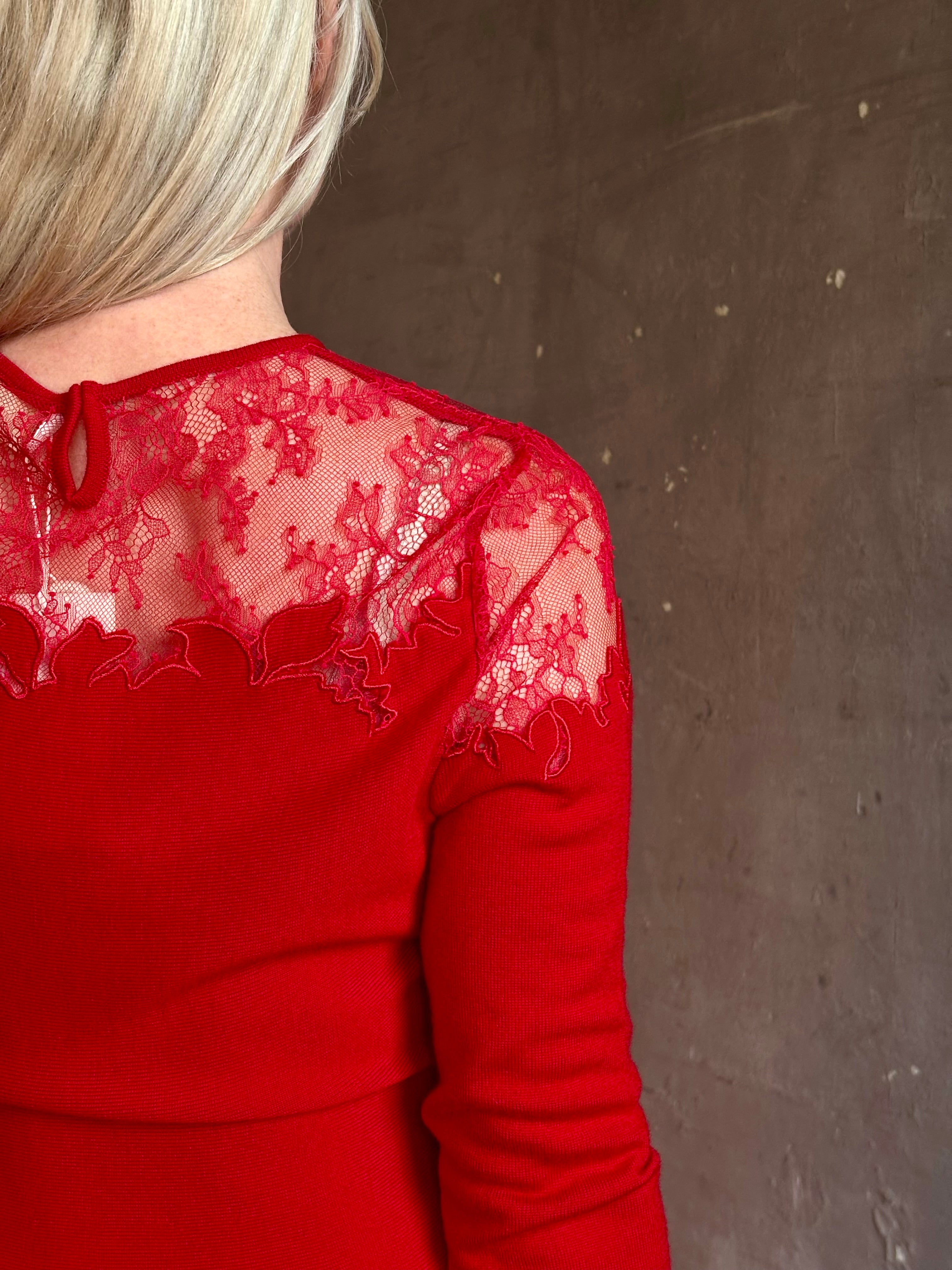 Mature woman wearing designer Ulla Johnson's Clemence Long sleeve Lace Dress in Cerise red virgin wool knit with delicate lace at the bodice 