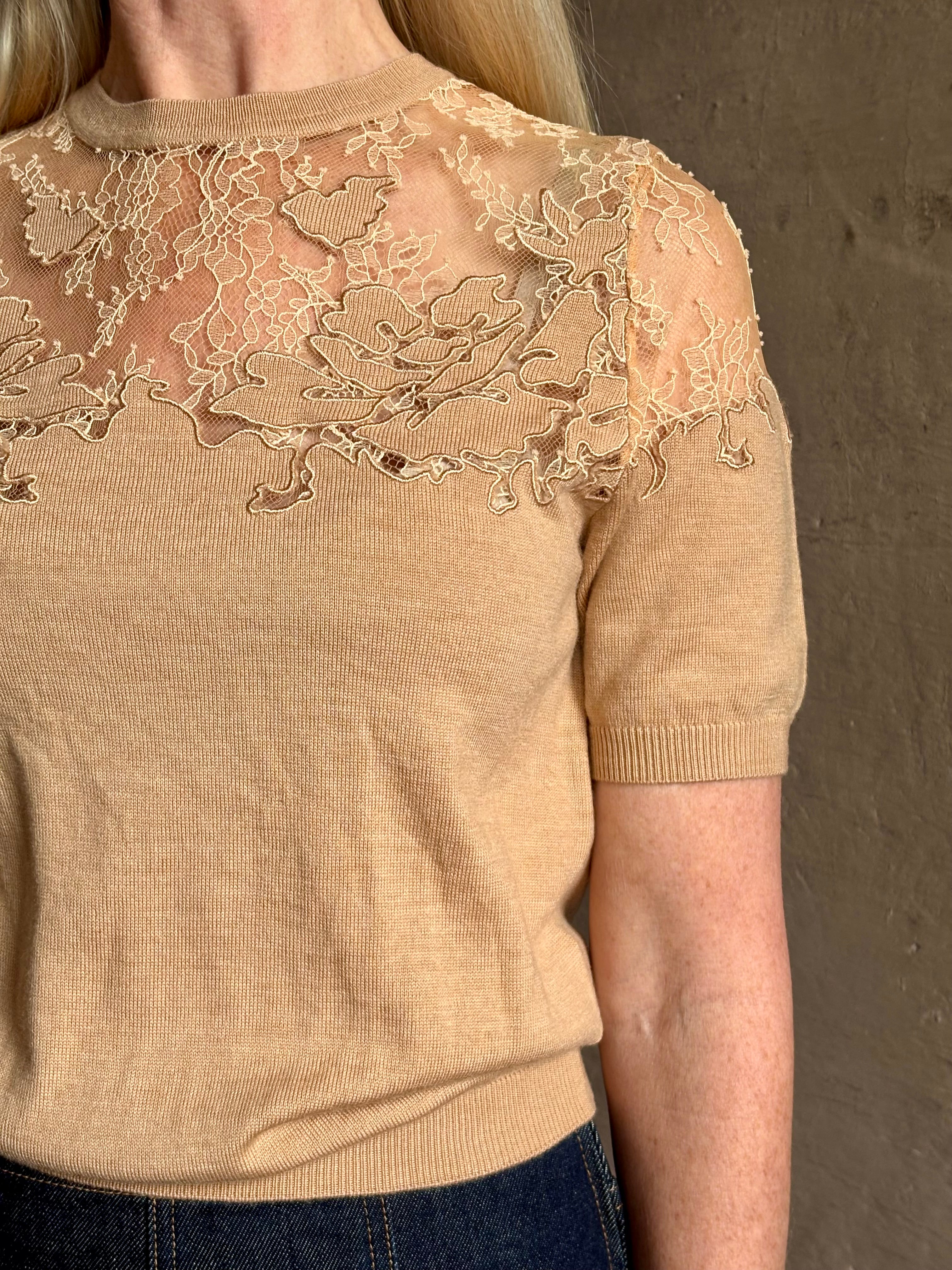 Mature woman wearing Ulla Johnson's Ella Short Sleeve Lace merino wool knit Top in Almond delicate lace detailing at the shoulders classic elegance