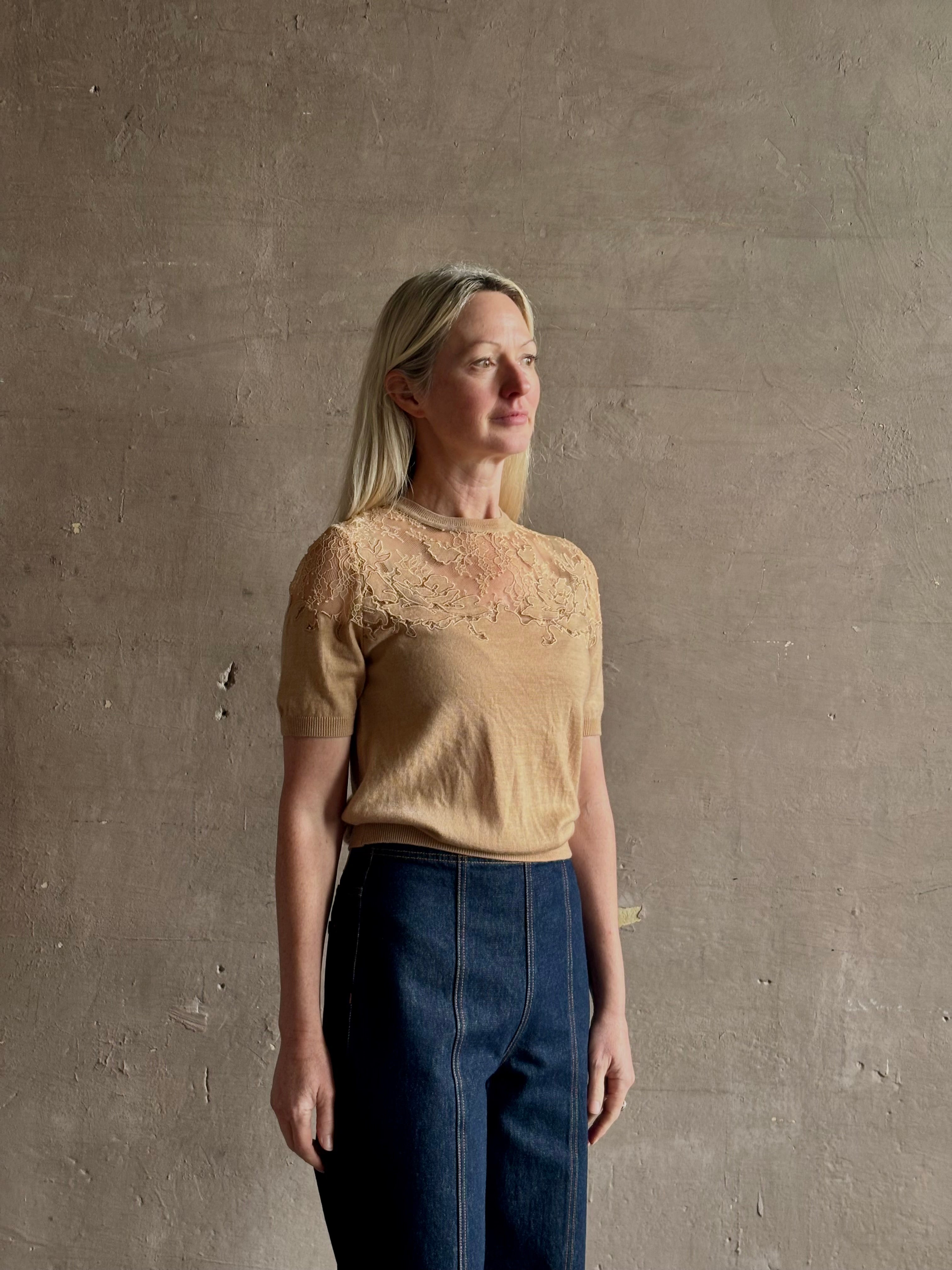 Mature woman wearing Ulla Johnson's Ella Short Sleeve Lace merino wool knit Top in Almond delicate lace detailing at the shoulders Romantic artistic elegance