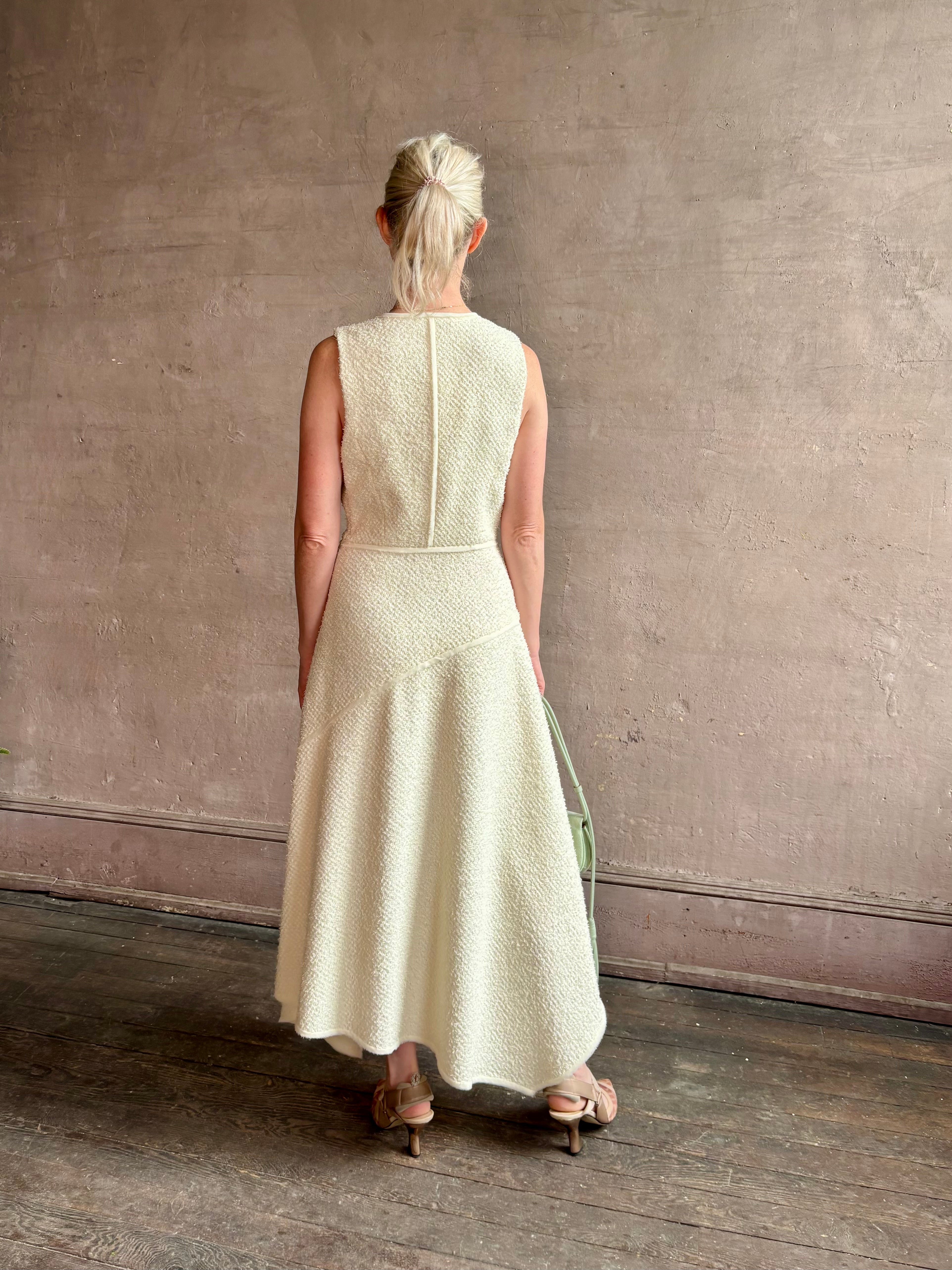 Woman wearing luxury Ulla Johnson Florence Dress concealed zip closure sleeveless fit and flare design