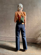 Mature woman wearing Women's designer Gracie sleeveless Cotton Top from Ulla Johnson rendered in a rich abstract Agate print composed of dark green, mint green, burgundy, terra cotta, and sienna and crafted from lightweight cotton poplin