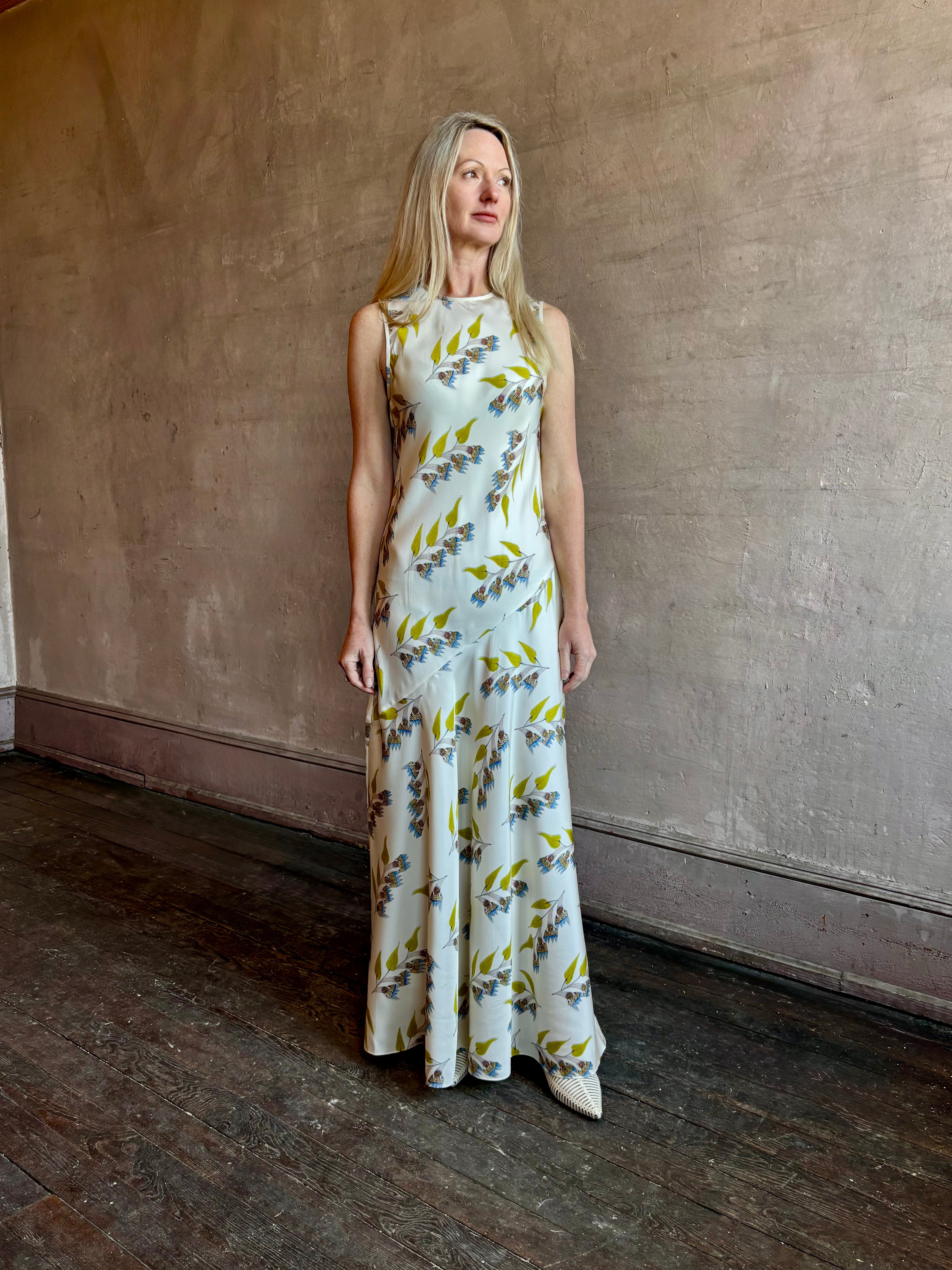 Image of mature woman wearing timeless limited edition ULLA JOHNSON Gaea maxi silk Dress with contemporary floral prints from artist Anna Zemankova