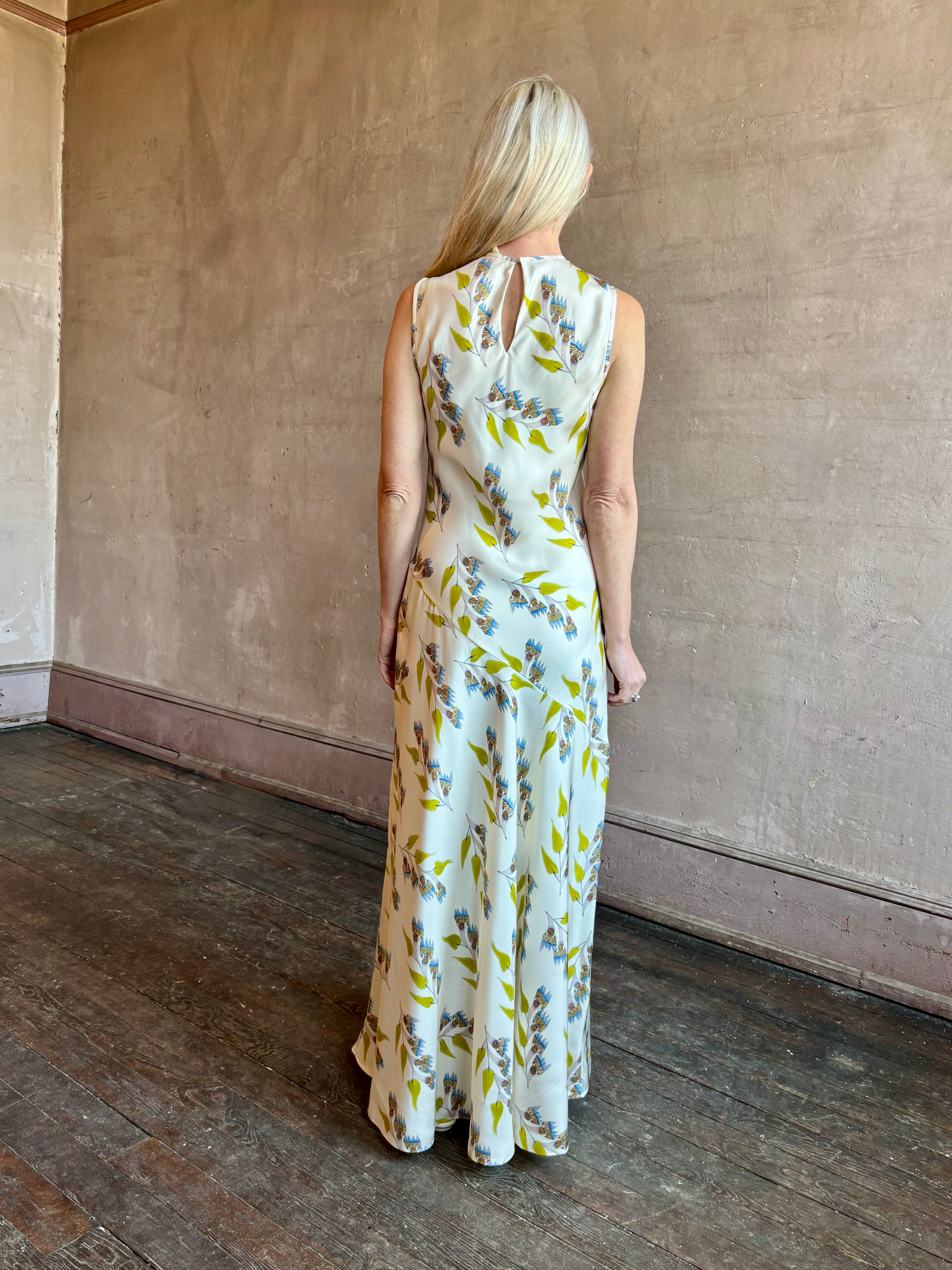 Image of mature woman wearing timeless limited edition ULLA JOHNSON Gaea maxi silk Dress with contemporary floral prints from artist Anna Zemankova