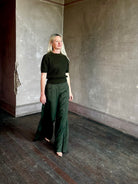 Mature woman wearing designer Ulla Johnson Imara Short Sleeve dark green Sweater with a dimensional open weave