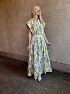 Image of woman wearing limited edition ULLA JOHNSON Lausanne silk occasion dress with pockets in sophisticated floral pattern by painter Anna Zemankova