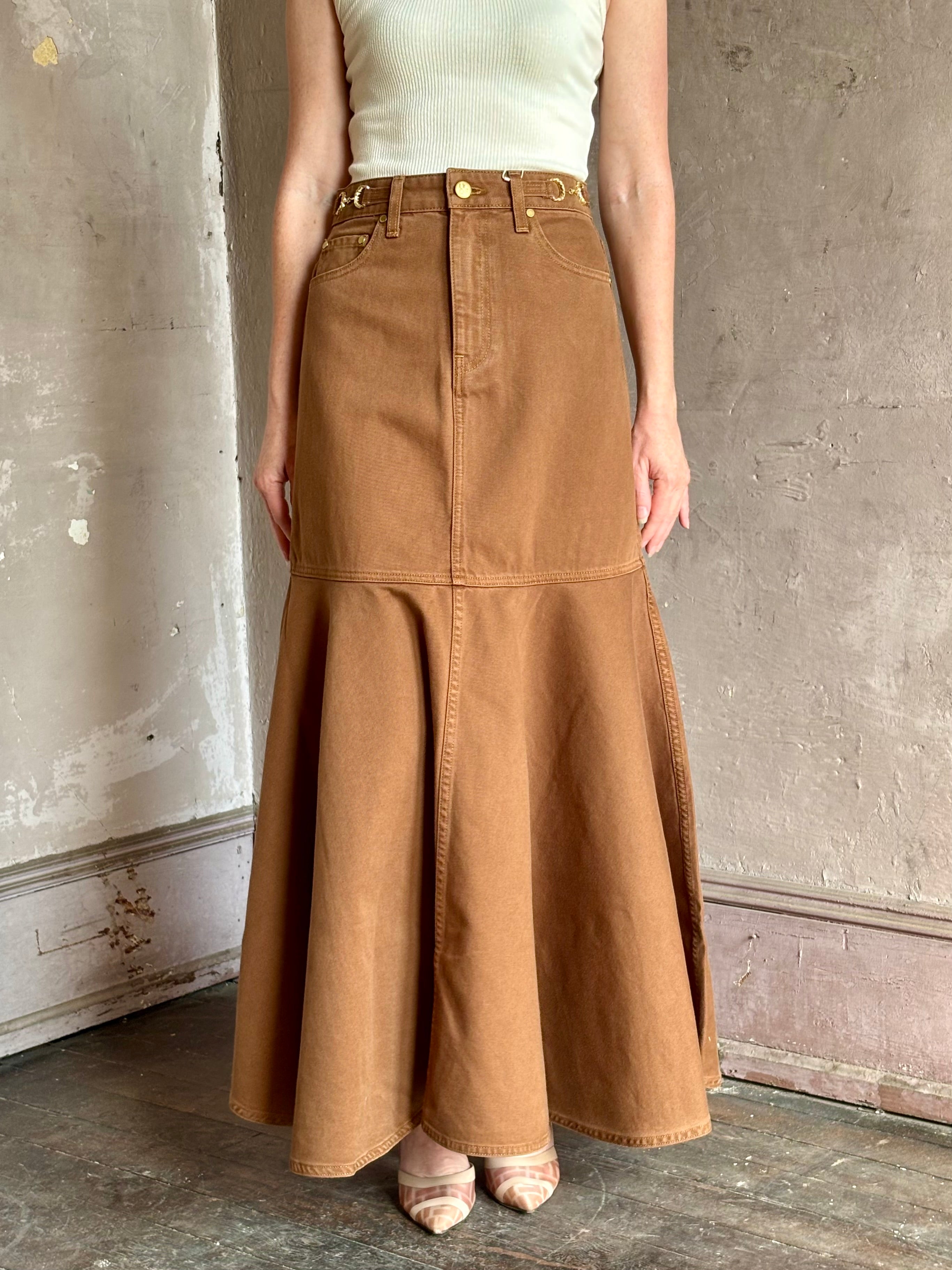 Mature woman wearing elevated designer Ulla Johnson Madelyn cotton denim mermaid skirt made in USA 