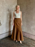 Mature woman wearing designer Ulla Johnson sculptural Madelyn cotton denim skirt made in USA 