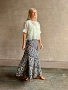 Mature woman wearing Ulla Johnson Marceline maxi knit cotton Skirt women's designer knit skirt Oasis colorway 