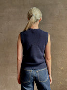 Mature woman wearing designer Margot sleeveless Knit Top from Ulla Johnson rendered in a rich midnight blue and knitted from 100% cotton with refined design details and a crew neckline for everyday sophistication