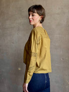 Ulla Johnson Marlowe Long Sleeve Cotton Top in muted green with pintucking and intricate lace crochet 