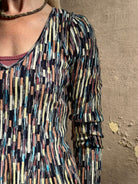 Mature woman wearing premium cotton ULLA JOHNSON Rosalia Peplum Knit Top Oasis long sleeves v-neck