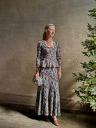 Mature woman wearing premium cotton ULLA JOHNSON Rosalia Peplum Knit Top Oasis long sleeves v-neck