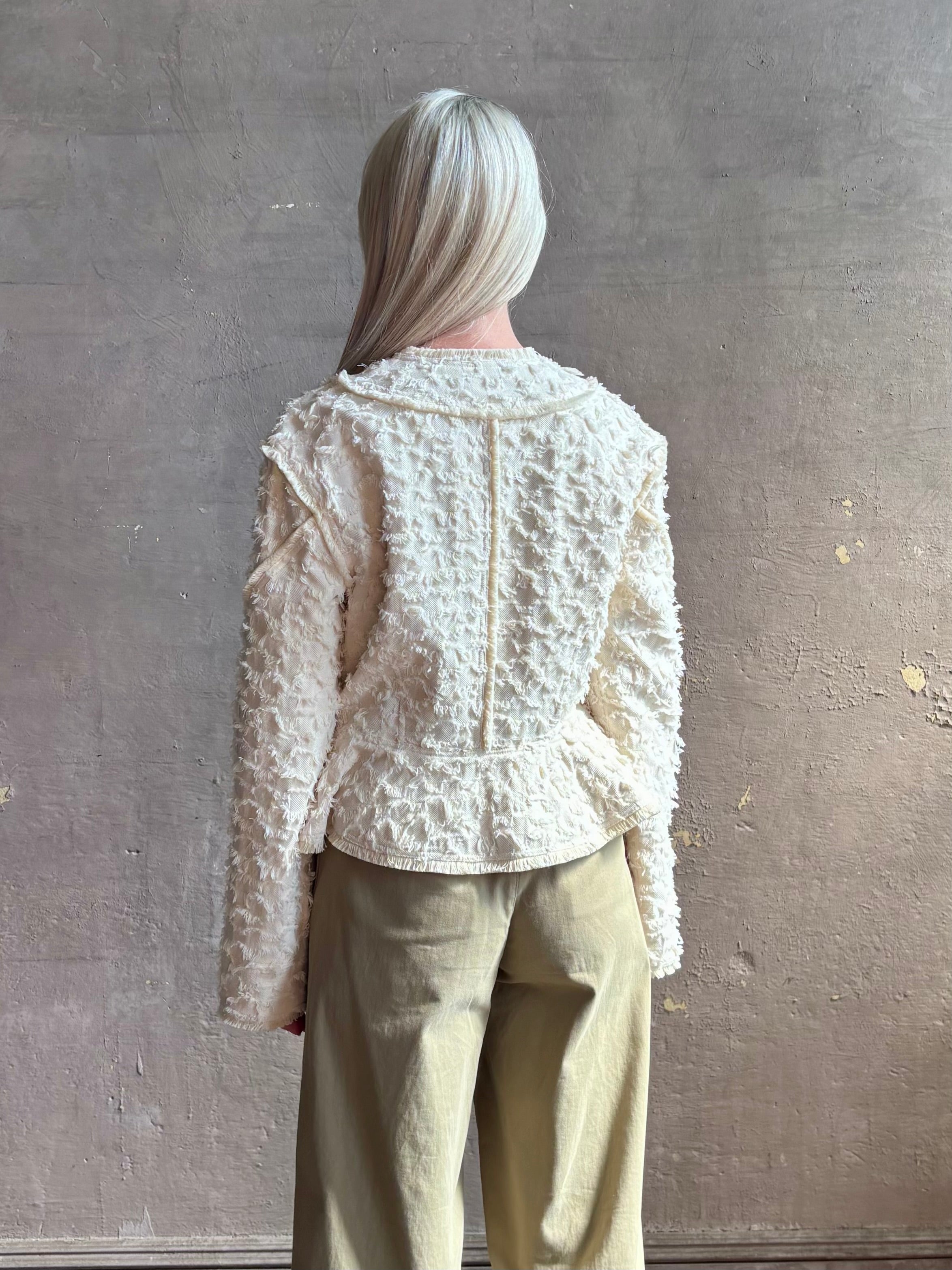 woman wearing designer Ulla Johnson Rosalind tailored peplum premium cotton Jacket checkered fringe texture