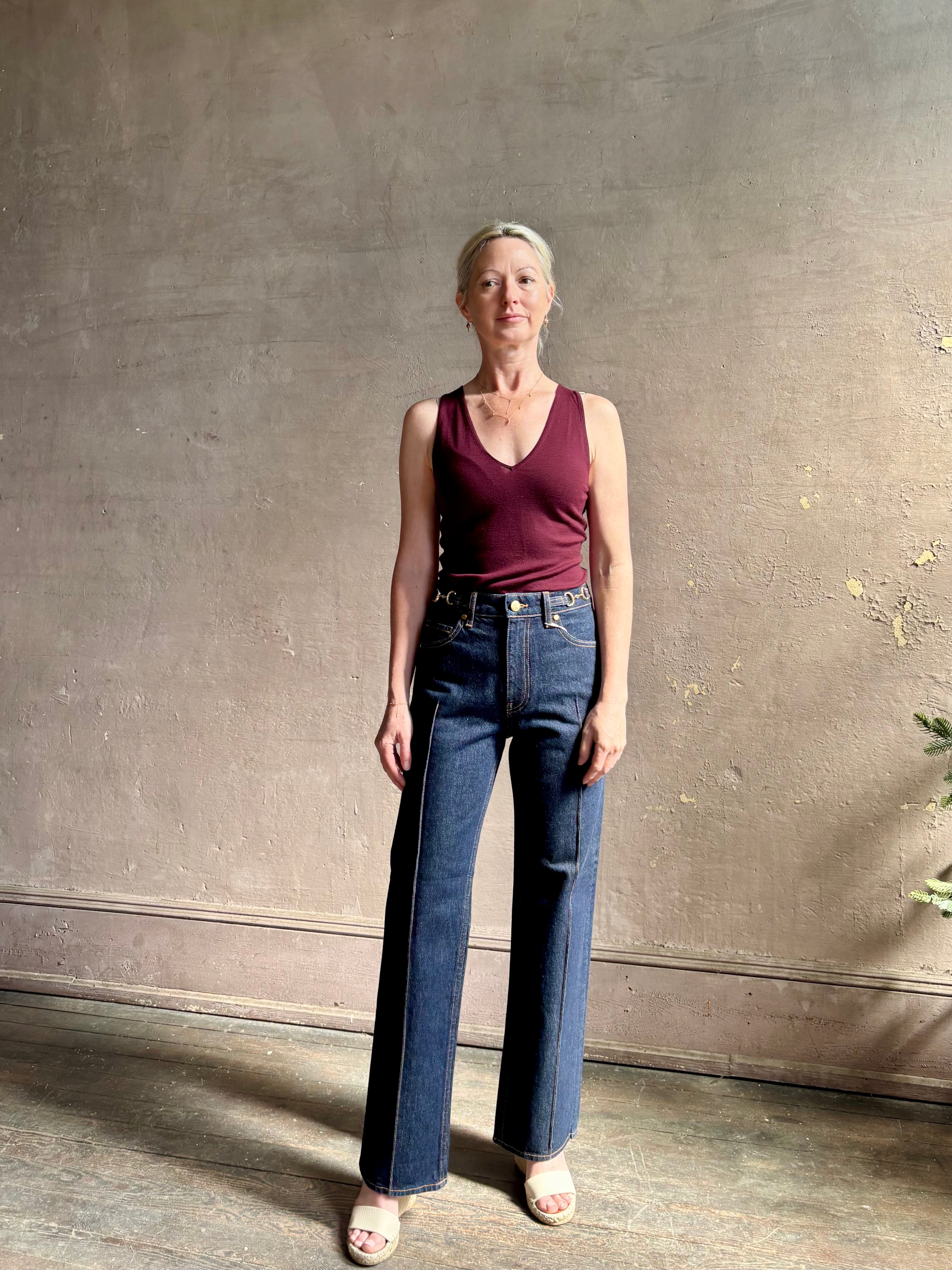 Woman wearing ULLA JOHNSON  Agatha Straight Leg Pintuck Rigid Denim jean in Tigris wash with horsebit detail
