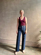 Woman wearing ULLA JOHNSON  Agatha Straight Leg Pintuck Rigid Denim jean in Tigris wash with horsebit detail
