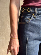 Woman wearing ULLA JOHNSON  Agatha Straight Leg Pintuck Rigid Denim jean in Tigris wash with horsebit detail