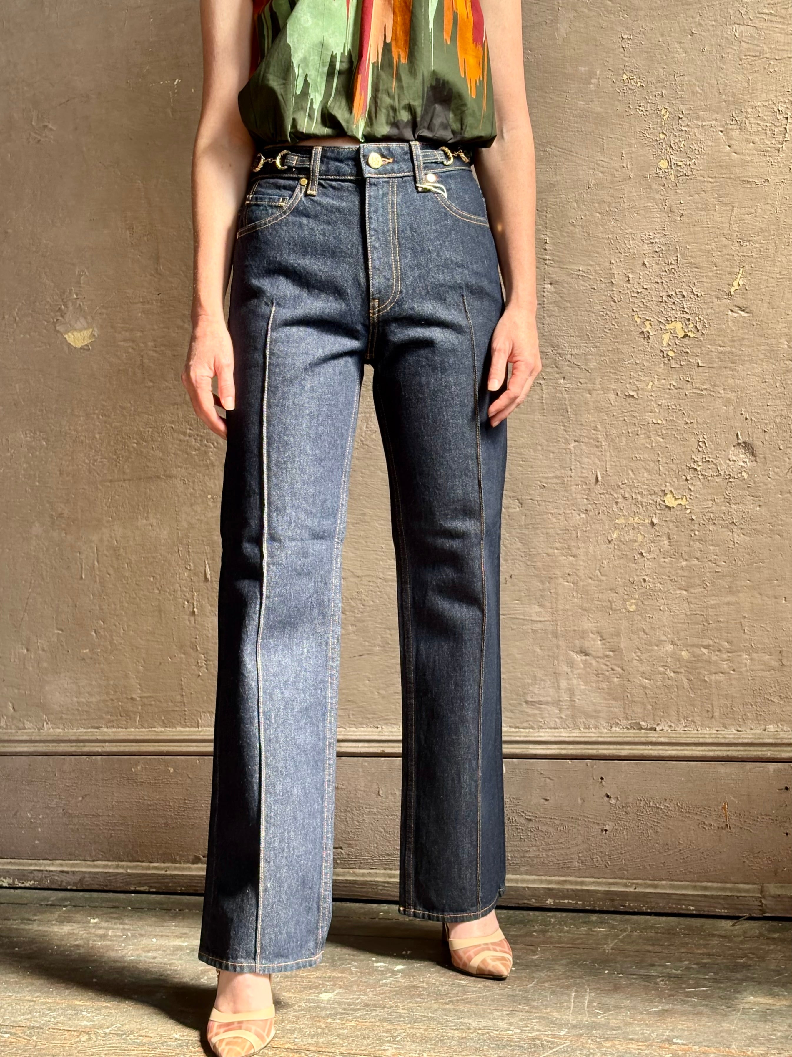 Woman wearing ULLA JOHNSON  Agatha Straight Leg Pintuck Rigid Denim jean in Tigris wash with horsebit detail