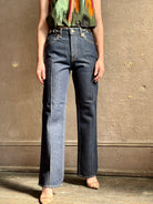 Woman wearing ULLA JOHNSON  Agatha Straight Leg Pintuck Rigid Denim jean in Tigris wash with horsebit detail