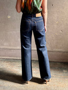 Woman wearing ULLA JOHNSON  Agatha Straight Leg Pintuck Rigid Denim jean in Tigris wash with horsebit detail