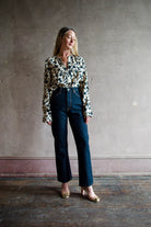 Image featuring a woman wearing the Agnes jean by Ulla Johnson with a  high rise straight, cropped leg with contrast stitching in Deep Indigo Tigris wash.