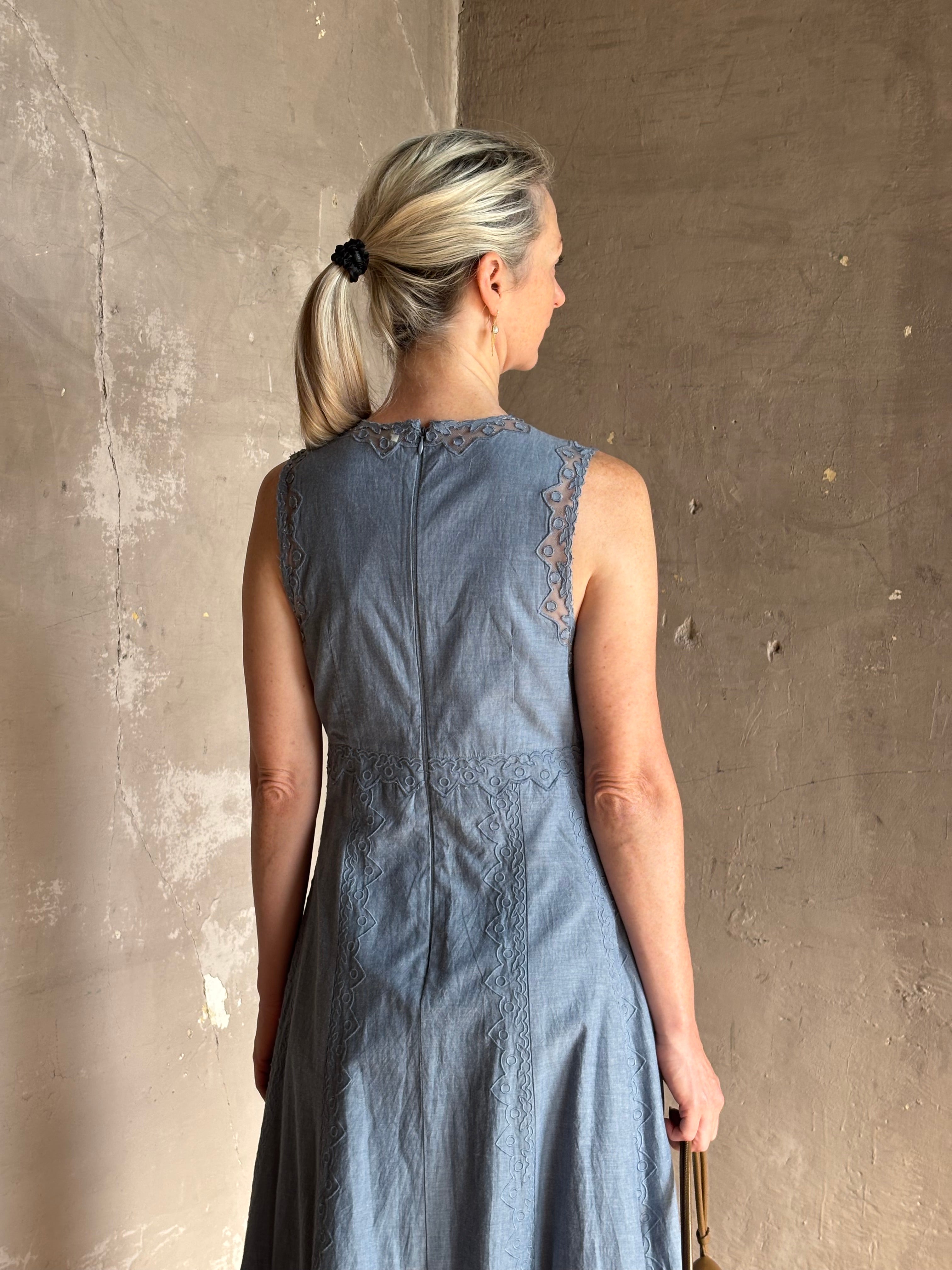 Woman wearing classic Ulla Johnson Anela midi chambray dress delicate lace details sleeveless fit and flare