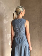 Woman wearing classic Ulla Johnson Anela midi chambray dress delicate lace details sleeveless fit and flare