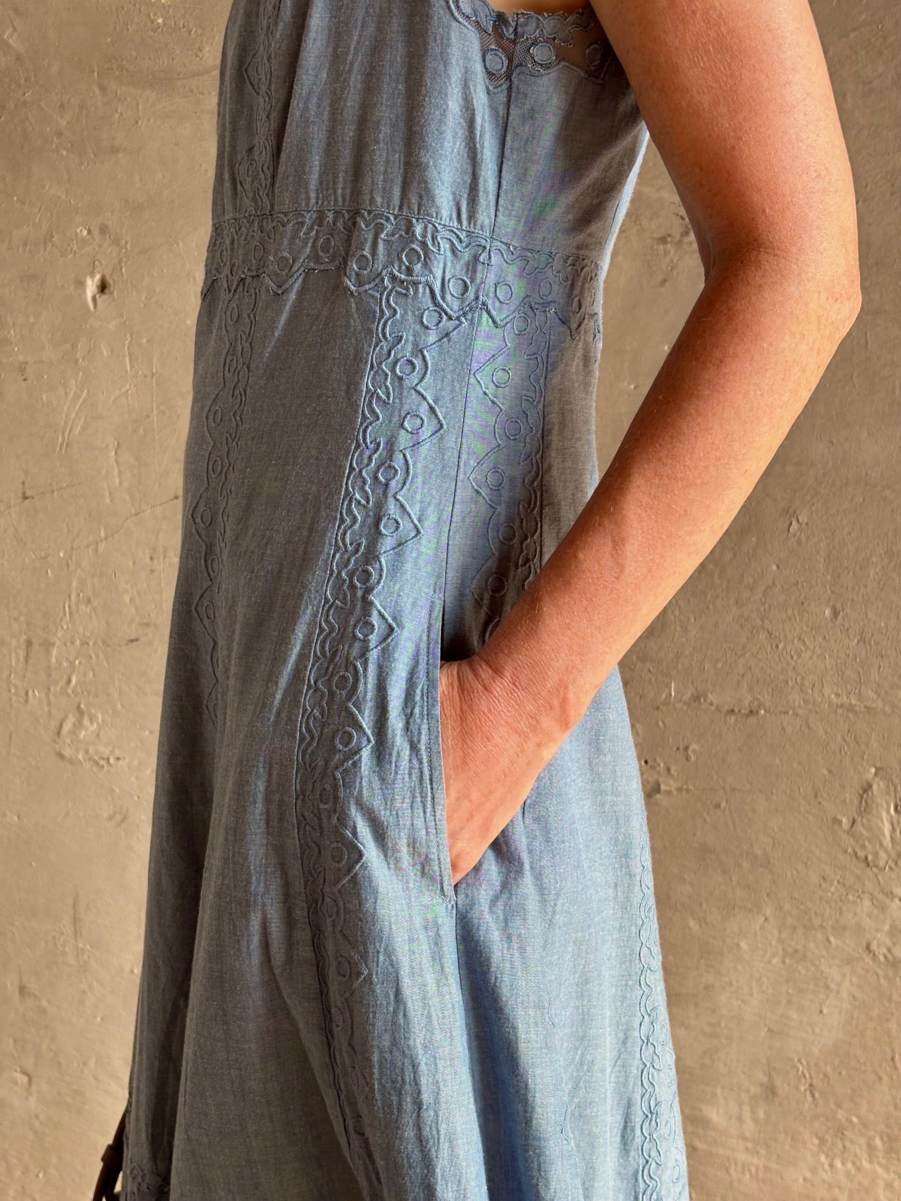 Woman wearing classic Ulla Johnson Anela midi chambray dress delicate lace details sleeveless fit and flare