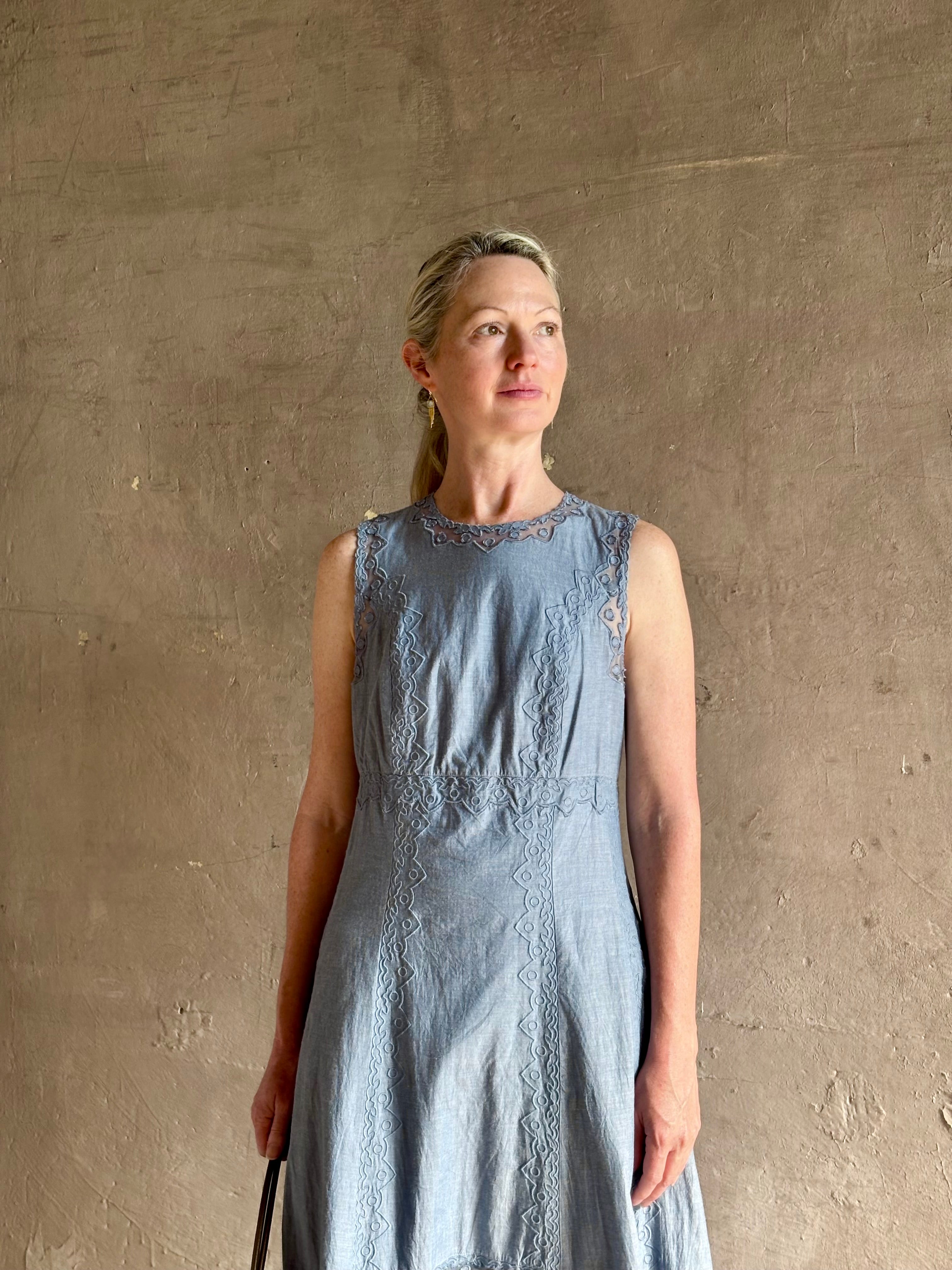 Woman wearing classic Ulla Johnson Anela midi chambray dress delicate lace details sleeveless fit and flare