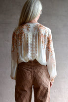 Back image of a woman wearing the Ulla Johnson Aster Blouse and Veronica Beard Taylor Jeans