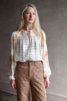 Image of a woman wearing the Ulla Johnson Aster Blouse and Veronica Beard Taylor Jeans