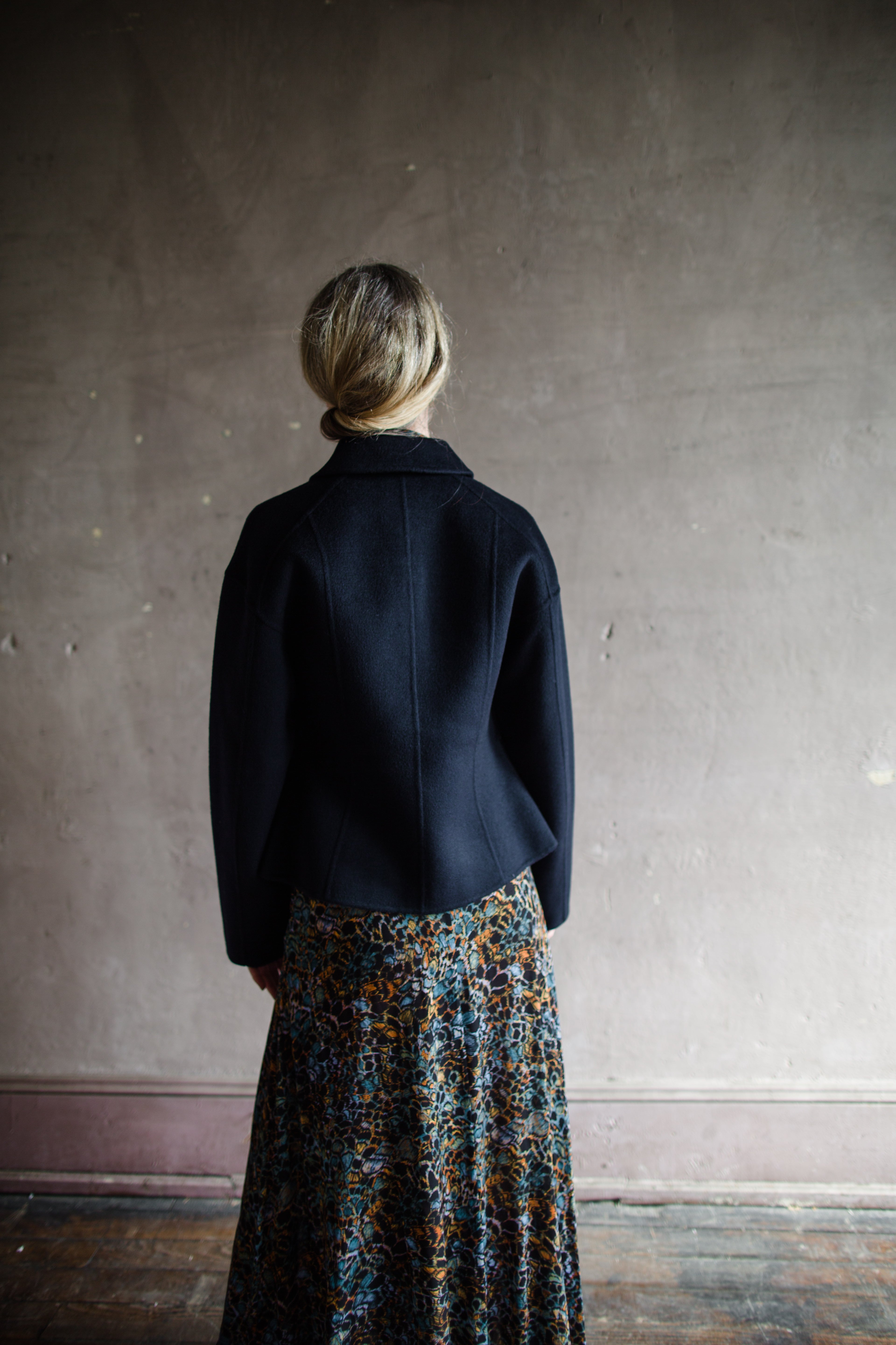 Image featuring a woman wearing the wool & cashmere Carina jacket by Ulla Johnson features a zip front and full sleeve with front pockets in navy blue.