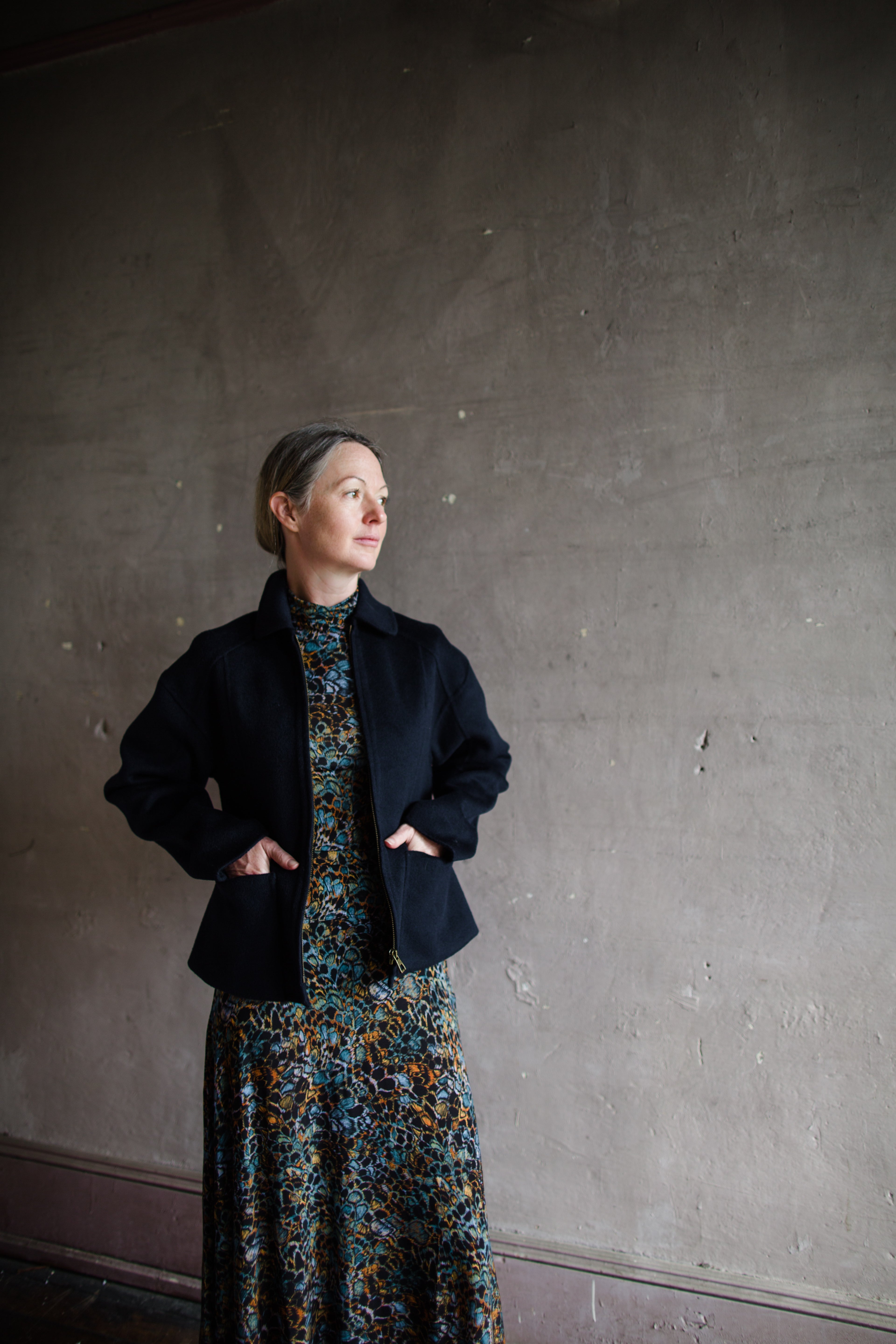 Image featuring a woman wearing the wool & cashmere Carina jacket by Ulla Johnson features a zip front and full sleeve with front pockets in navy blue.