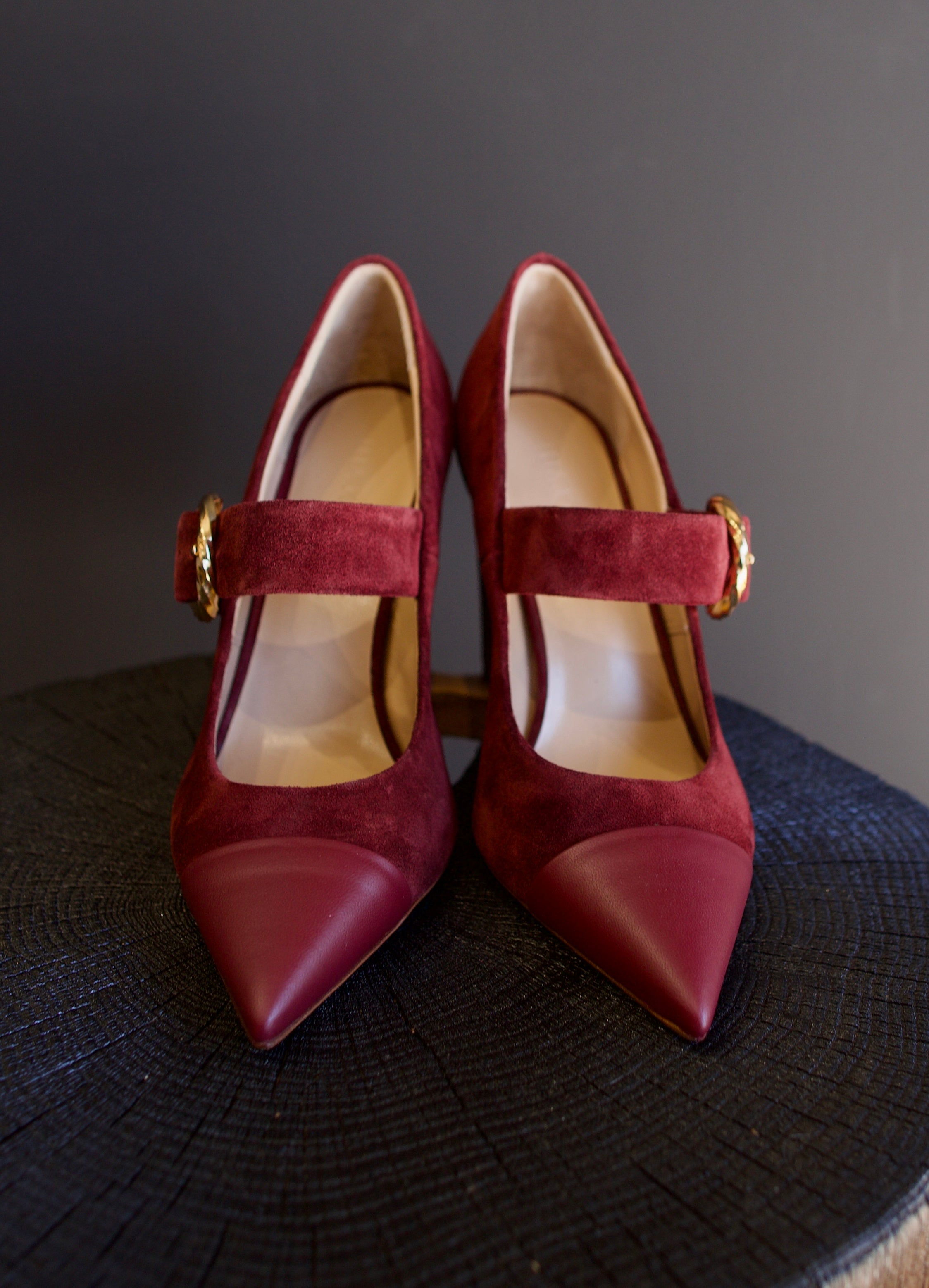 Image featuring the Kiki burgundy suede heels by Ulla Johnson with a pointed leather toe, gold finish buckle closure and a 3.5" tall block heel.