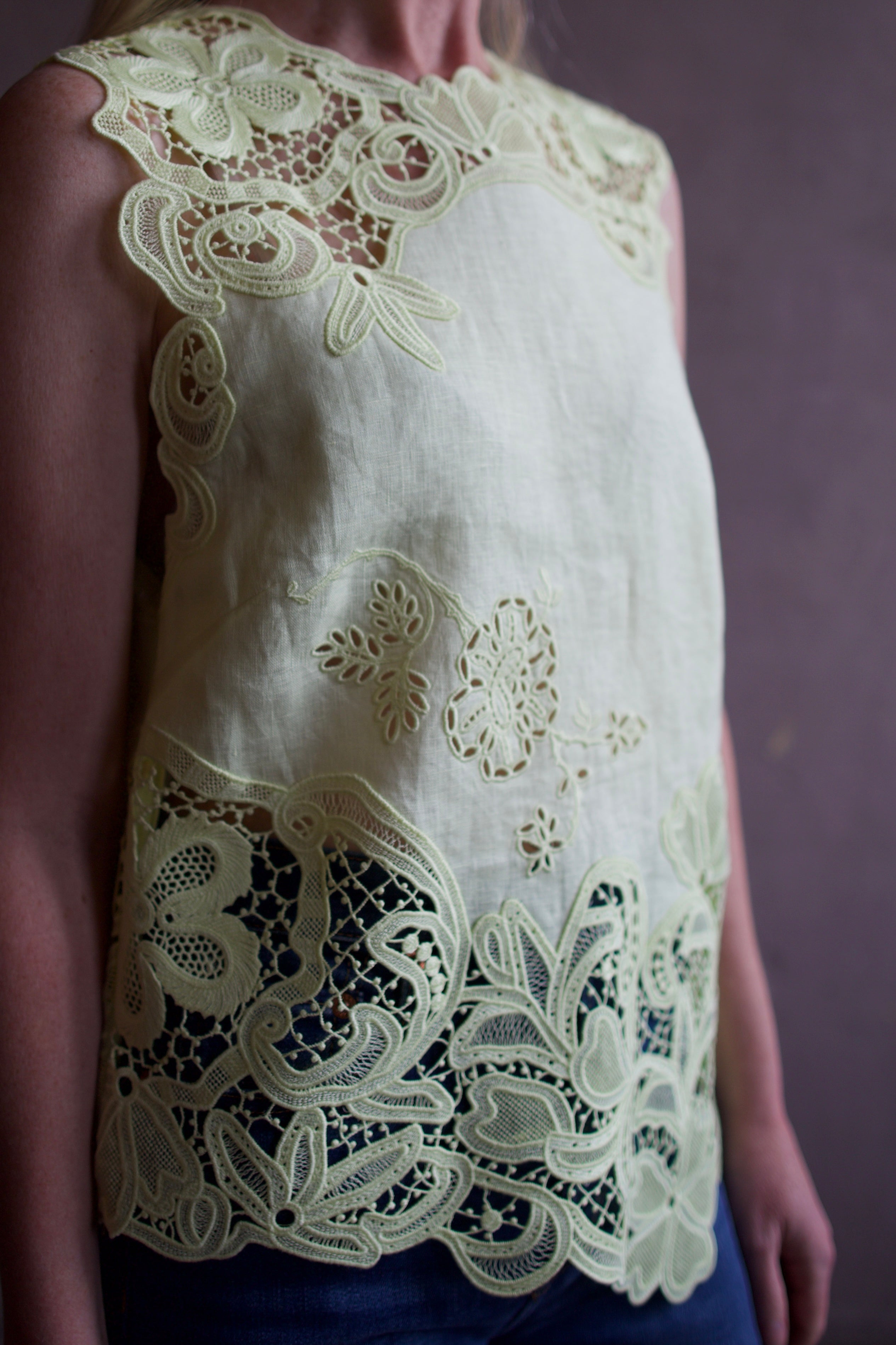 Mature woman wearing luxury designer Ulla Johnson Marlis premium linen top in citrine distinctive lace appliqué 