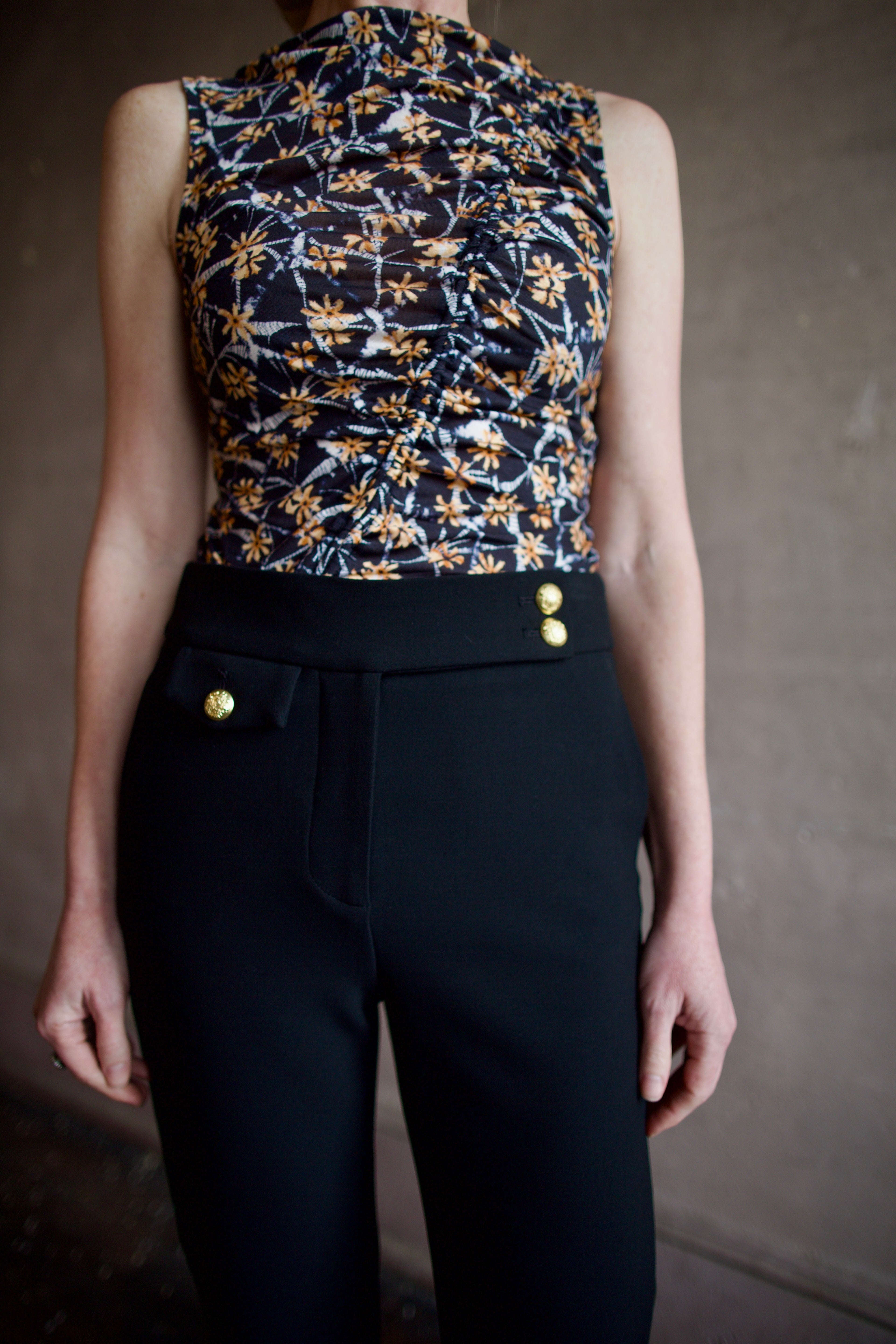 Woman wearing the ulla johnson medea top in sustainable premium lyocell construction and flattering ruching detail for elevated casual wear