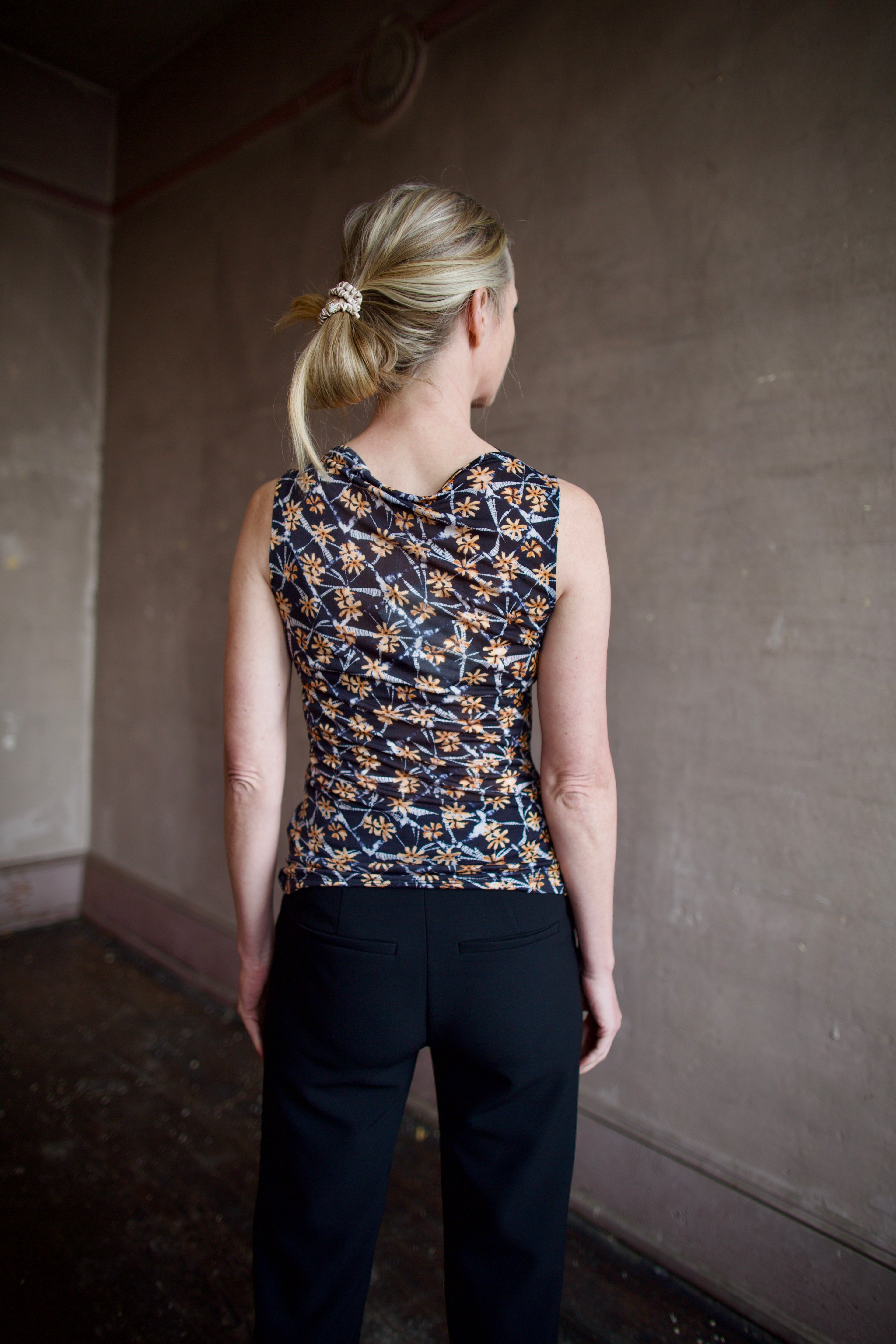 Mature woman wearing ulla johnson medea top in Aura floral print comfortable lightweight lyocell fabric sleeveless with slim fit