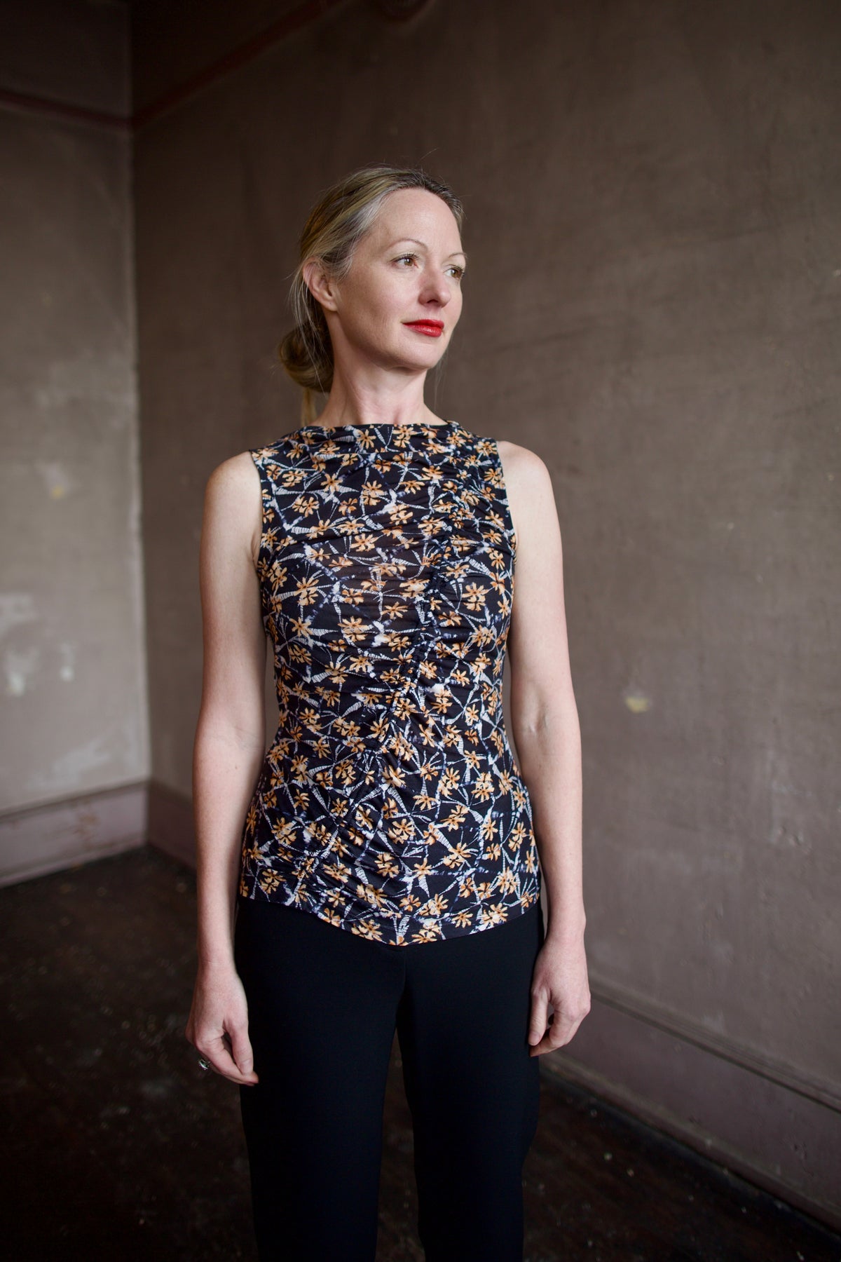 Mature woman wearing ulla johnson medea top in Aura sustainable premium lyocell  flattering ruching for elevated casual wear