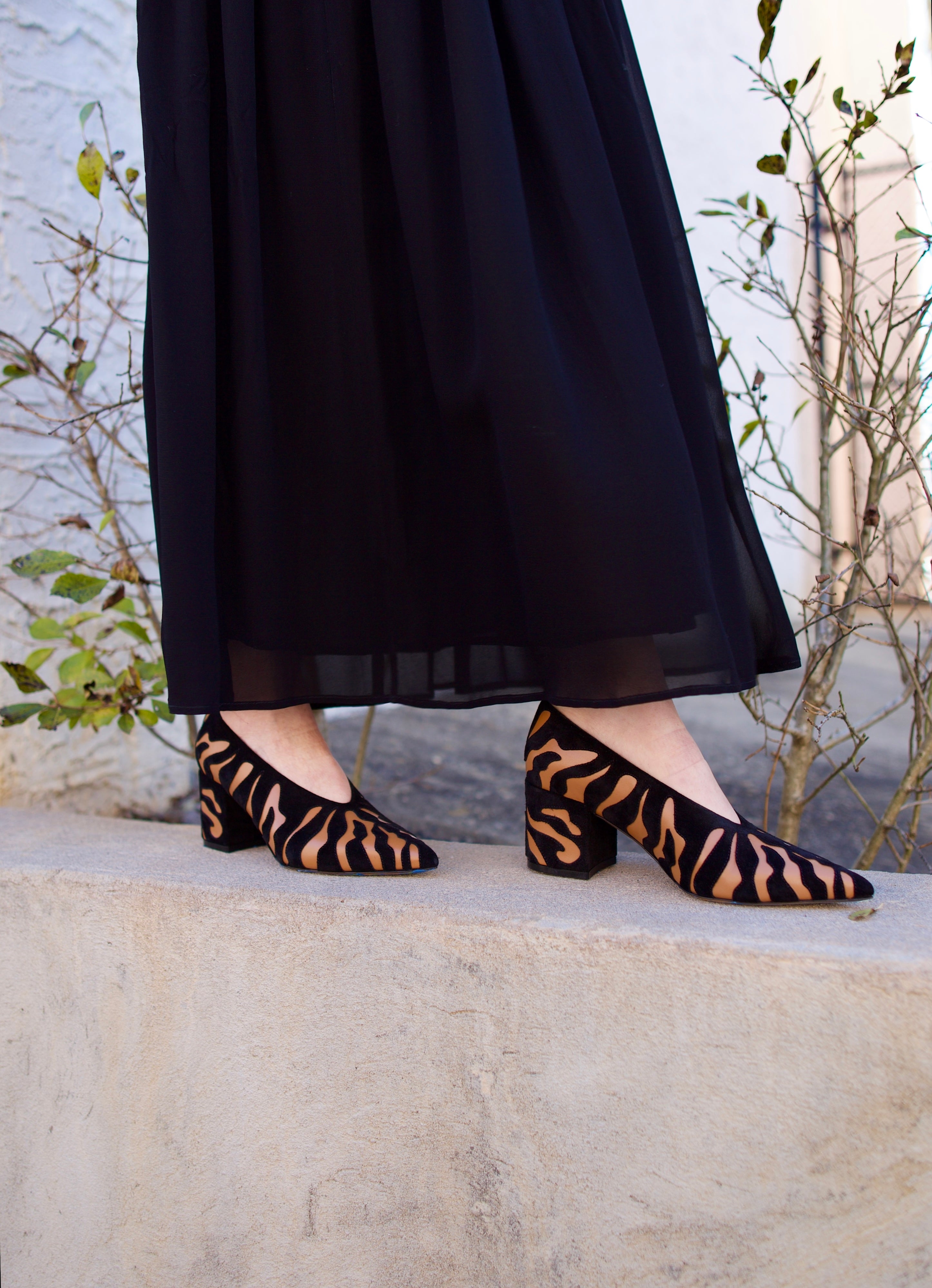 image of woman wearing the Ulla Johnson Polline pumps and the Miya skirt