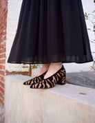 image of woman wearing the Ulla Johnson Polline pumps and the Miya skirt