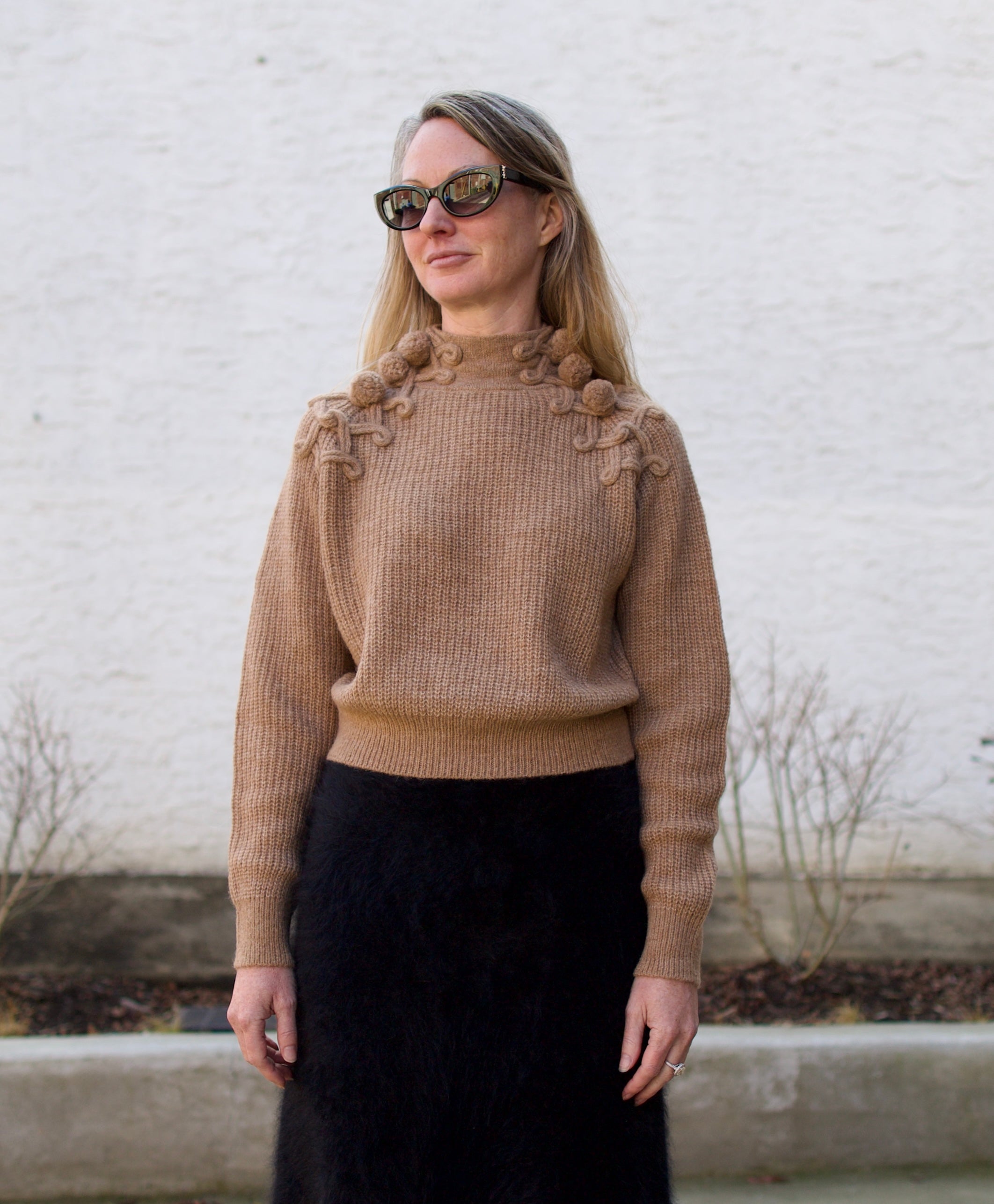 image of a woman wearing the Ulla Johnson Reina pullover and Lisa Yang brushed cashmere skirt