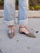 Ulla Johnson's Daria Flats in Black/Tan — hand-woven vegan leather with a pointed toe and T-strap. Textural, artisan-crafted everyday elegance.