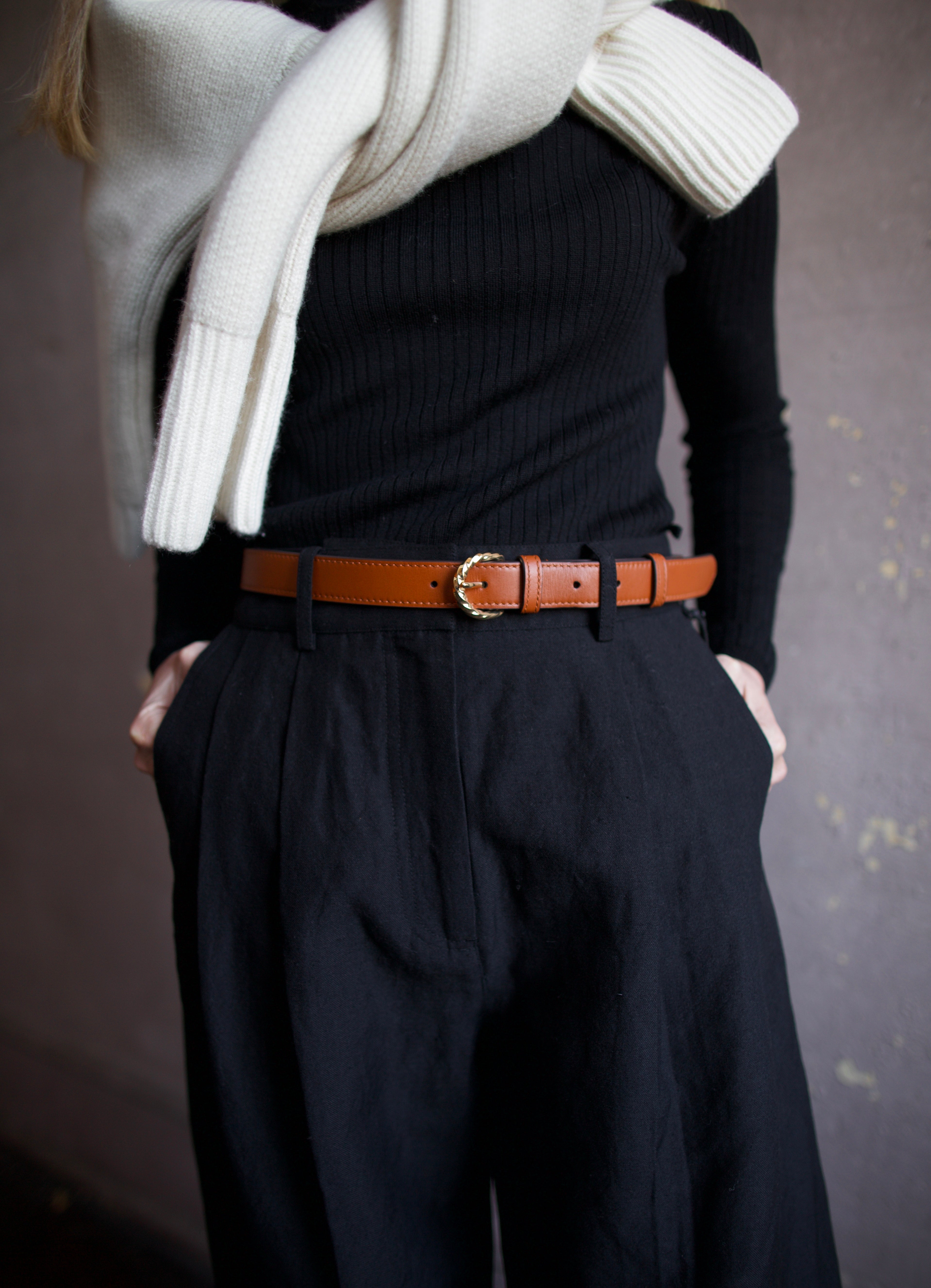 Mature woman wearing Ulla Johnson gia leather belt with gold finish twist buckle in Sierra brown