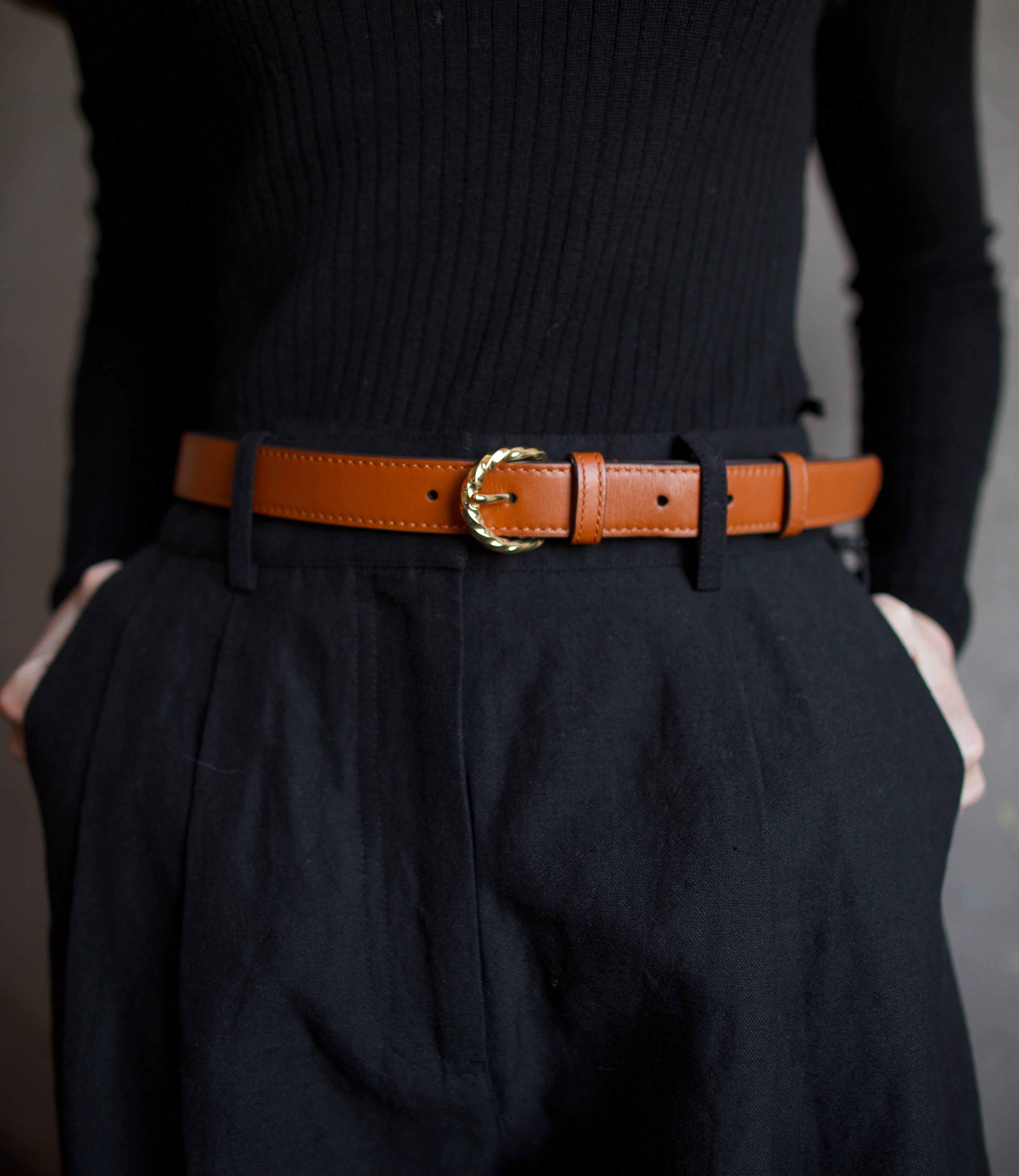Mature woman wearing Ulla Johnson gia leather belt with gold finish twist buckle in Sierra brown