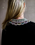 Image featuring a woman wearing the black velvet Julien top by Ulla Johnson with a split neckline, tie closure and embellished collar with sequins and beading.