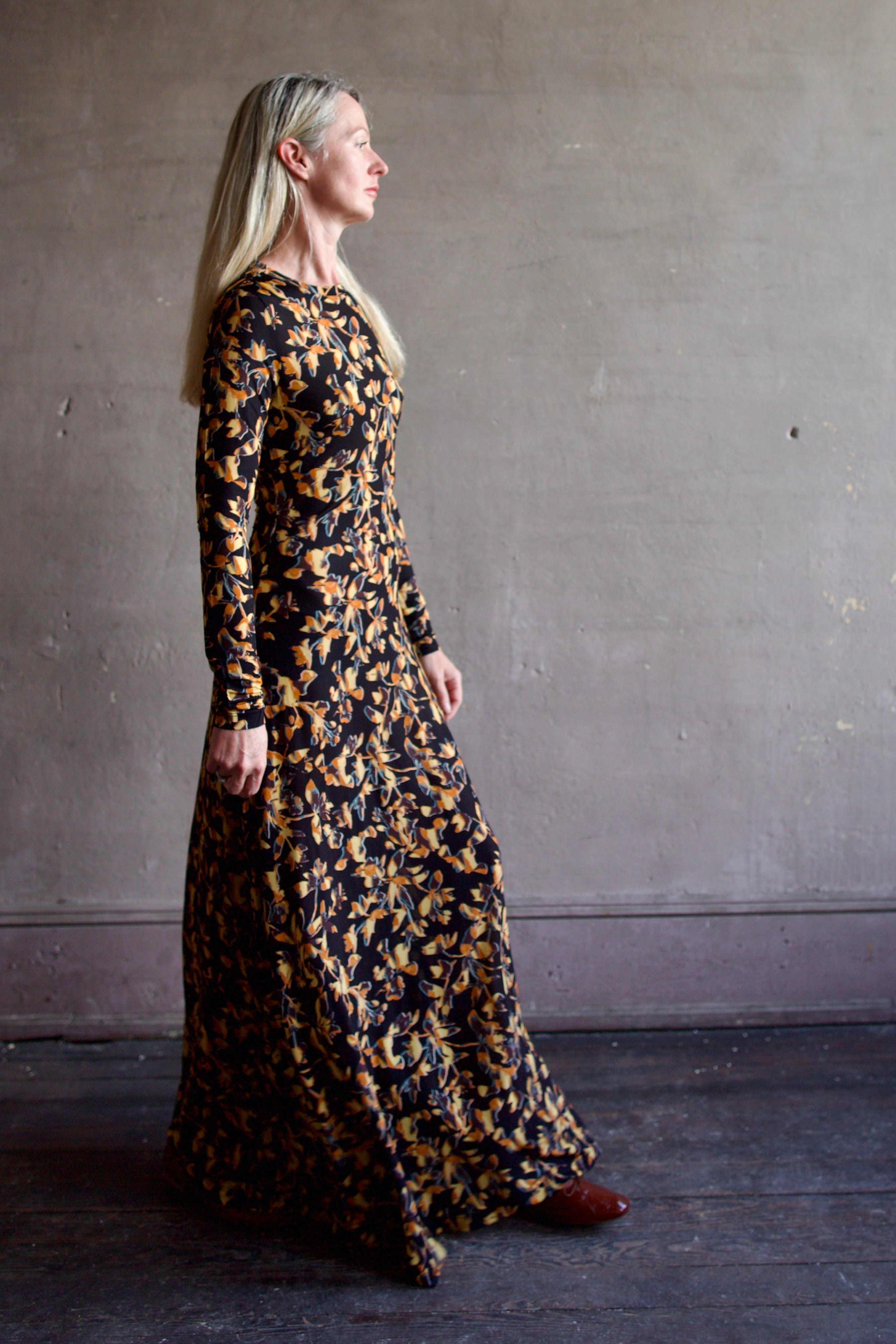 Model wearing the Amari dress from designer Ulla Johnson featuring long sleeves maxi length & fall patterned 